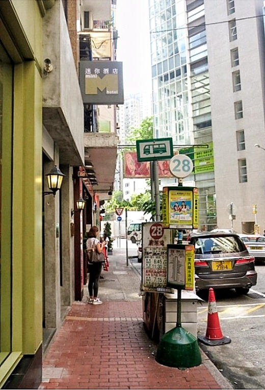 The green Bus Stop 28 sign will help you find Mini Hotel! Spot the little M sign above it