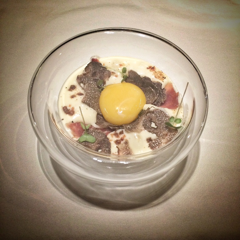 52 degree egg slowly cooked in olive oil for an hour. Underneath there's caramelized onion, bacon, potato foam, topped with winter truffles from Perigord, Iberico ham and porcini powder