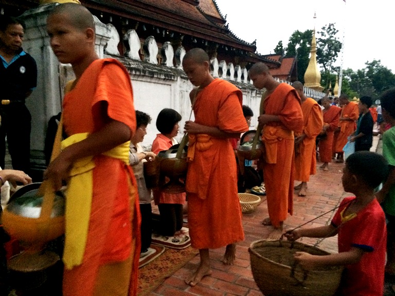 The tak bat or alms-giving is a sacred ritual that happens before dawn
