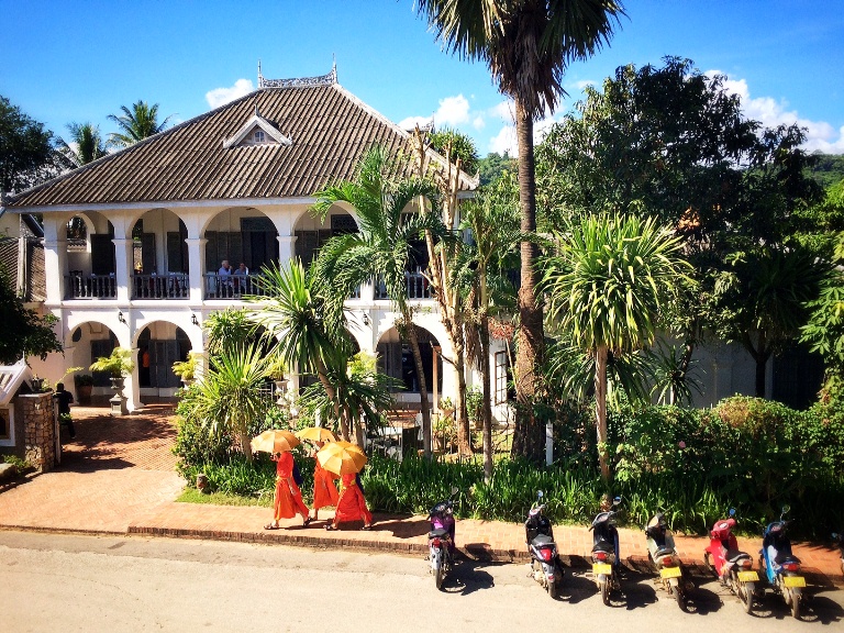 This is Luang Prabang in a snapshop= colonial architecture (of Villa Santi) + motorbikes + Buddhist monks.