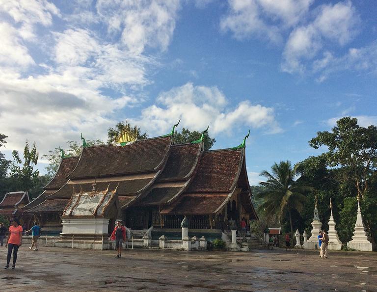 Wat Xieng Thong is often highlighted for its ornamented roof that evokes a bird displaying its wings. (Trivia: If there are 17-19 ornaments on the roof then it's a royal building; if it's 3-5 then it's a village temple. This one is obviously royal-- look at the gold ornaments in the middle!)