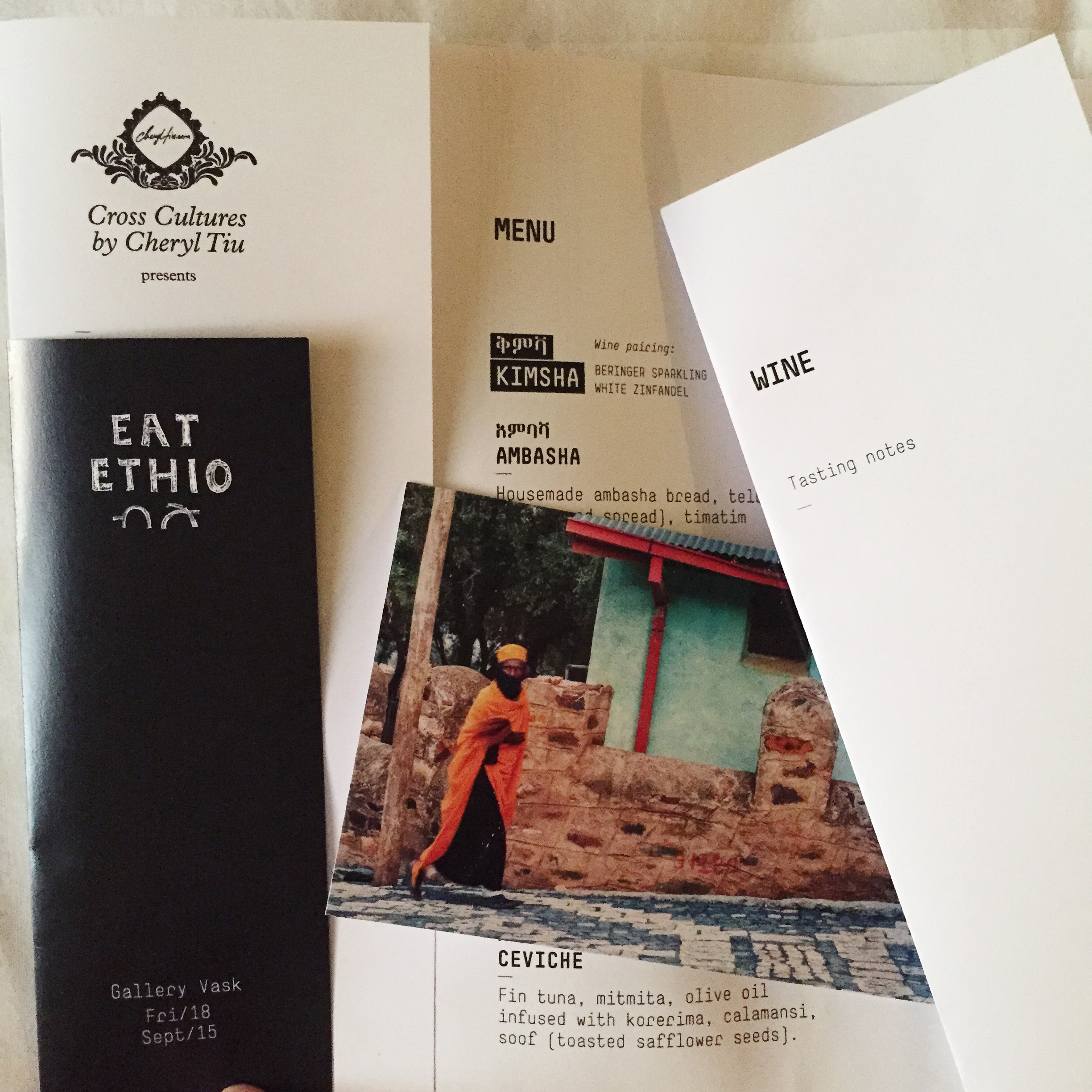 Cross Cultures x Eat Ethio menu, and photos of Ethiopia by Cheryl Tiu converted into postcards used as place cards for guests