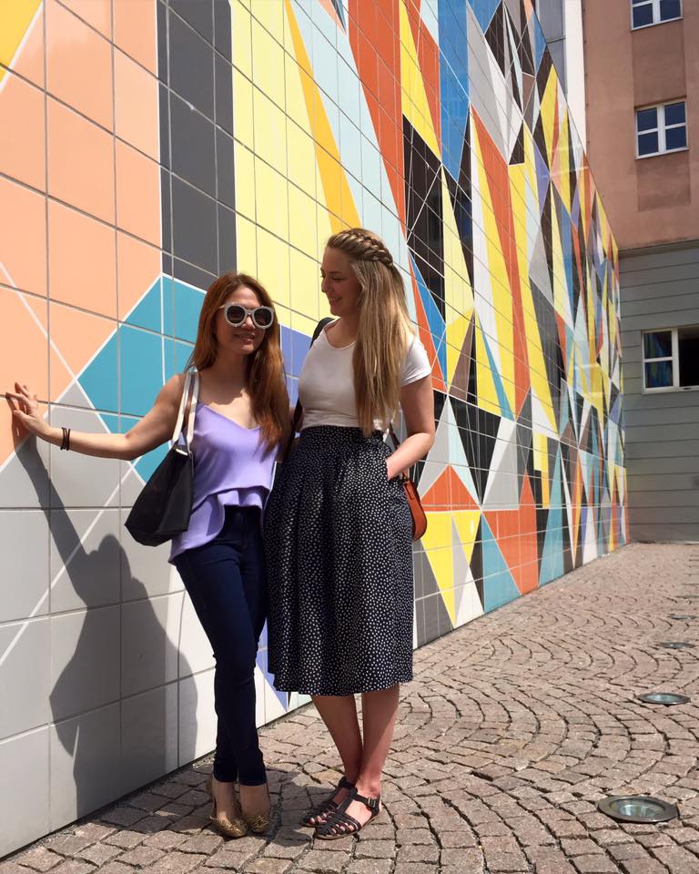 Cheryl Tiu and Phoebe Lee of Little Grey Box at a gemoetric wall in old town Dusseldorf, Germany