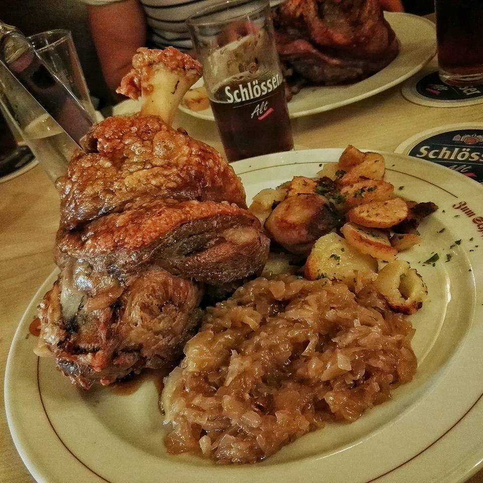 Grilled pork knuckle with sauerkraut and potatoes at Brauerei zum Schiffchen, Altstadt, Dusseldorf, Germany