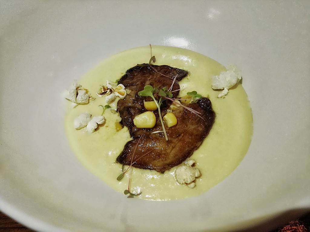 Pan-fried Soulard foie gras served on corn foam and topped with popcorn 