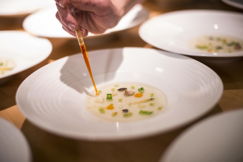 A beautiful start: Spring vegetable stock with vegetable emulsion, carrots, baby broad beans, flat beans, flowers and leaves by Joan Roca / El Celler de Can Roca (Photo by Miguel Toña - MTVisuals)