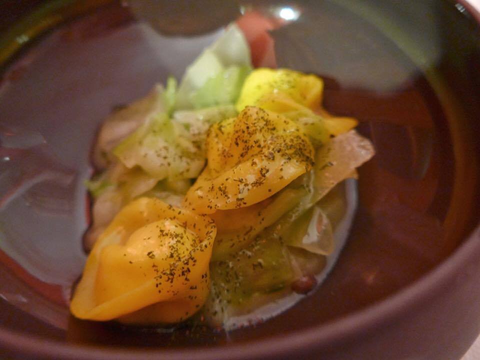 Sheep cottage cheese ravioli with bone marrow, lovage, in a prosciutto broth and topped with hazelnuts (Photo by Cheryl Tiu)