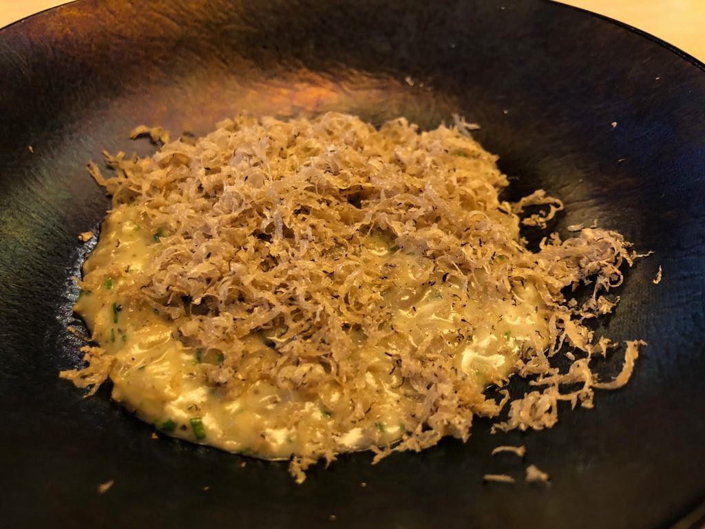 The Catbird Seat's signature Sunflower and Black Truffle Risotto (Photo by Cheryl Tiu)