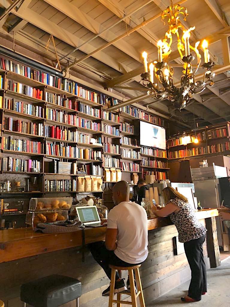 Next Door is an art studio, coffee shop, and lounge. It was created by C&I Studios to be a community hub, and features a 20-foot tall floor to ceiling library, a bar, and outdoor seating area. Coffee is curated by Brew Urban Cafe. (Photo by Cheryl Tiu)
